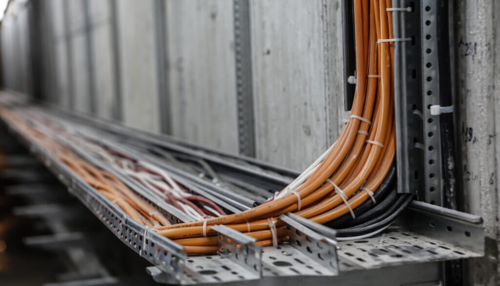 Industrial fiber optic cable conduit installed and bundled together with zip ties.