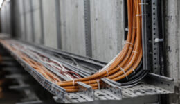 Industrial fiber optic cable conduit installed and bundled together with zip ties.